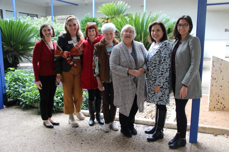 Guests smile alongside Catholic Charities staff during their campus tour.