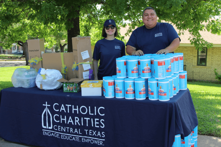 Allison (left) serving at a CCCTX material distribution event for families in need in Waco, TX.