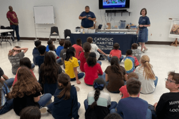 Allison (top right) hosting a Catholic Social Teaching fair at a Catholic School in Killeen as part of the CCCTX Parish Relations team.