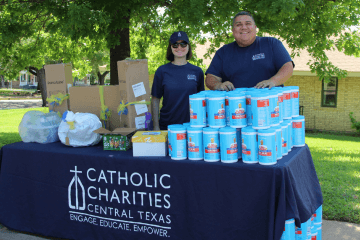 Allison (left) serving at a CCCTX material distribution event for families in need in Waco, TX.